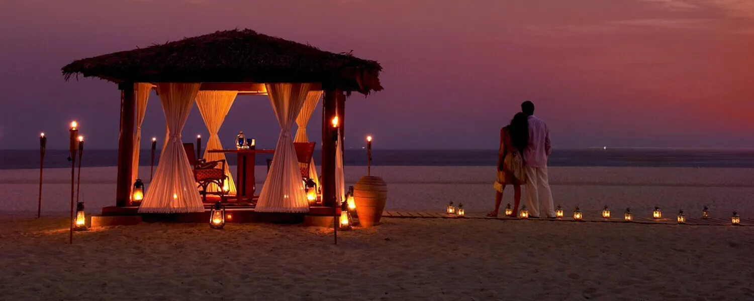 Beach dinner setting at sunset